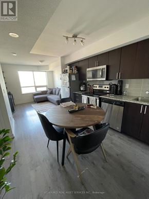 Toronto (Dovercourt-Wallace Emerson-Junction) condo for rent - A modern kitchen and dining area with a wooden table and chairs.