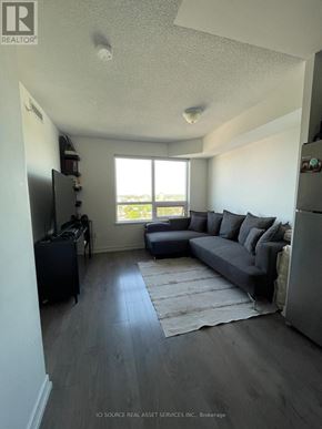 Toronto (Dovercourt-Wallace Emerson-Junction) condo for rent - A living room with a grey couch and a television.