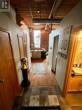 Guelph (St. Patrick's Ward) condo for rent - A hallway with a brick wall and a sign that says 100.