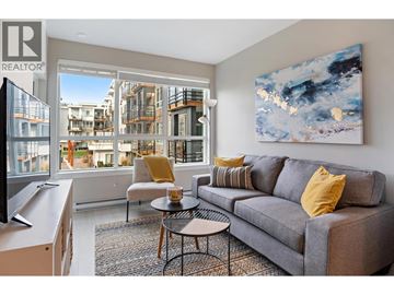 Tsawwassen apartment for rent - A living room with a grey couch and a painting on the wall.