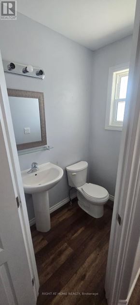 Kingston (City Northwest) townhouse for rent - A bathroom with a toilet, sink, and mirror.