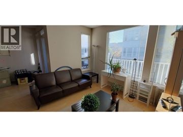 Richmond townhouse for rent - A living room with a brown couch and a sign that says REALTOR.