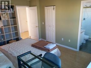 Richmond townhouse for rent - A bedroom with a bed, chair, and closet.