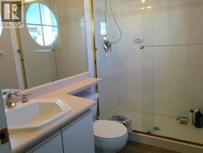 Richmond townhouse for rent - A white toilet sits next to a sink in a bathroom.