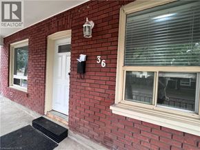 Brantford apartment for rent - A red brick house with a white door and window.