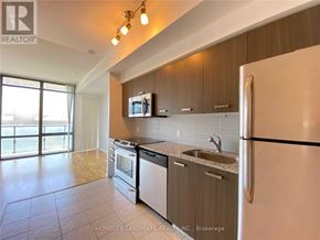 Toronto (Bay Street Corridor) condo for rent - A kitchen with a refrigerator, stove, and microwave.