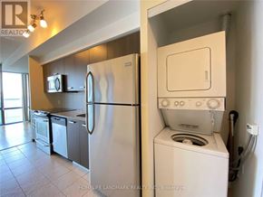Toronto (Bay Street Corridor) condo for rent - A white refrigerator and oven in a kitchen.