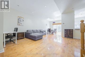 Richmond Hill (Rouge Woods) townhouse for rent - A living room with a grey couch and a wooden floor.