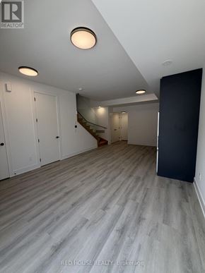 St. Catharines (Oakdale) townhouse for rent - A room with a staircase and a black door.