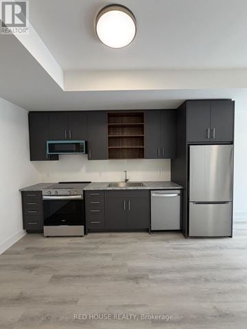 St. Catharines (Oakdale) townhouse for rent - A modern kitchen with dark grey cabinets and stainless steel appliances.