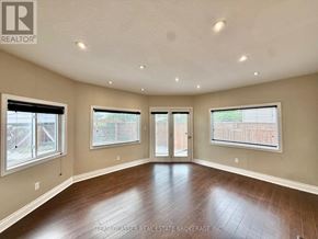 London South (South X) apartment for rent - A spacious room with wood flooring and a sliding glass door.
