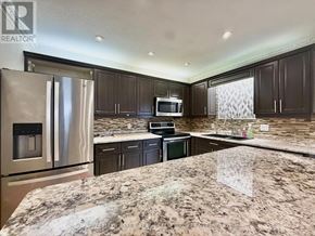 London South (South X) apartment for rent - A kitchen with granite countertops and stainless steel appliances.