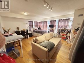 Toronto (Bay Street Corridor) condo for rent - A living room with a couch, a bed, and a television.