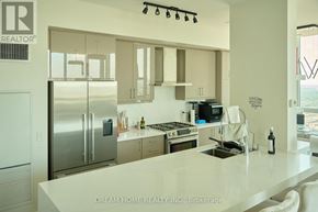 Mississauga (City Centre) condo for rent - A modern kitchen with a refrigerator, stove, and sink.