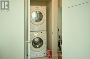 Mississauga (City Centre) condo for rent - A small laundry room with a washer and dryer.