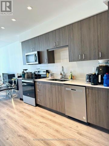Cambridge condo for rent - A modern kitchen with wooden cabinets and stainless steel appliances.