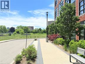 Kitchener condo for rent - A city park with a bench and a lamp post.