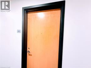 Kitchener condo for rent - A brown door with a black frame and a silver handle.