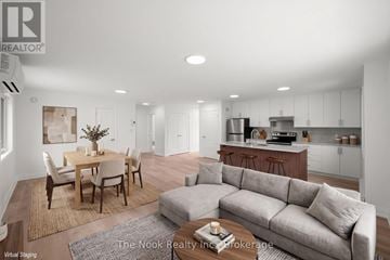 Oshawa (Mclaughlin) triplex for rent - A modern living room with a dining table and a grey sofa.