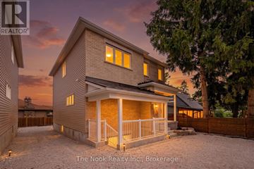 Oshawa (Mclaughlin) triplex for rent - A house with a porch and a fence in front of it.