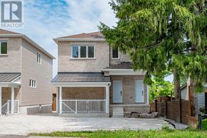 Oshawa (Mclaughlin) triplex for rent - A house with a brown roof and a white fence.