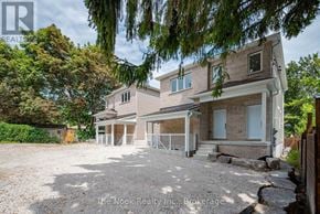 Oshawa (Mclaughlin) triplex for rent - A house with a gravel driveway and a garage is for sale.