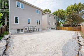 Oshawa (Mclaughlin) triplex for rent - A two-story house with a gravel driveway in front.
