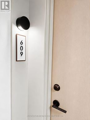 Toronto (Regent Park) condo for rent - Door number 609 is black and white and has a handle.