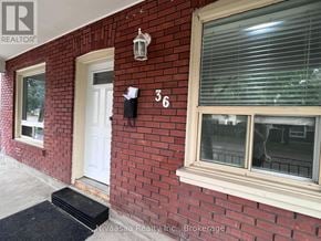 Brantford apartment for rent - A red brick house with a white door and window.