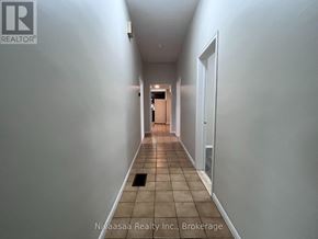 Brantford apartment for rent - A long hallway with a door at the end.