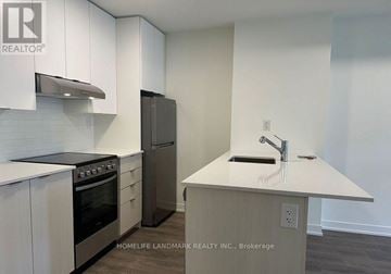Toronto (Beechborough-Greenbrook) townhouse for rent - A kitchen with white cabinets and a stainless steel oven.