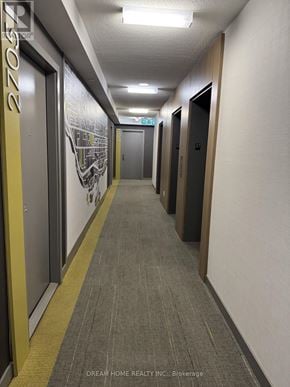 Toronto (Islington-City Centre West) condo for rent - A hallway with a carpeted floor and a wall mural.