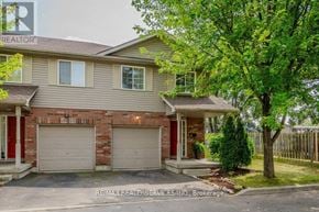 Cambridge townhouse for rent - A house with a red door and a garage.
