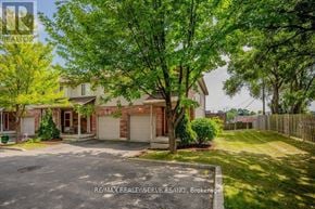 Cambridge townhouse for rent - A house with a tree in front of it.
