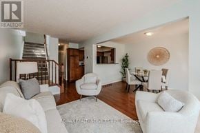 Cambridge townhouse for rent - A living room with a staircase and a dining area.