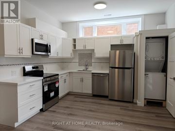 Toronto (Clairlea-Birchmount) apartment for rent - A kitchen with white cabinets and stainless steel appliances.