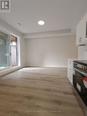 Toronto (Clairlea-Birchmount) apartment for rent - A kitchen with a stove top oven and wooden flooring.