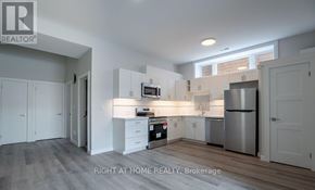 Toronto (Clairlea-Birchmount) apartment for rent - A kitchen with white cabinets and a stainless steel refrigerator.