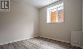 Toronto (Clairlea-Birchmount) apartment for rent - A room with a window and a wall-mounted air conditioning unit.