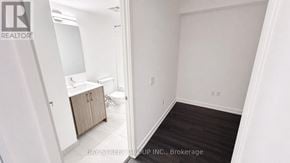 Toronto (Humber Heights) condo for rent - A white bathroom with a toilet, sink, and cabinet.