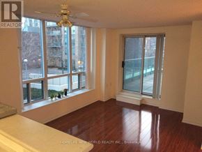 Toronto (Willowdale East) condo for rent - A room with a ceiling fan and a window overlooking a city street.