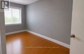 Toronto (Newtonbrook West) apartment for rent - A room with a wooden floor and a white door.