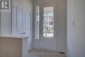 Oshawa (Kedron) townhouse for rent - A white door with a glass window is in a room with white walls.