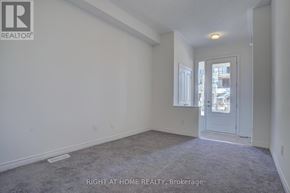 Oshawa (Kedron) townhouse for rent - A room with a carpeted floor and a door leading to another room.