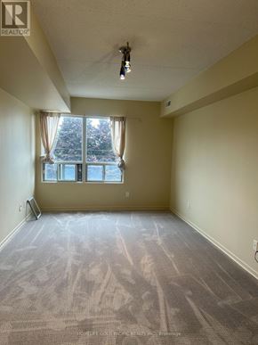 Aurora (Aurora Village) condo for rent - A room with a carpeted floor and a window with curtains.