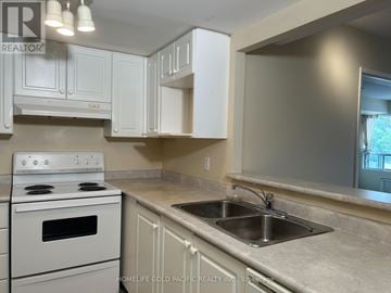 Aurora (Aurora Village) condo for rent - A kitchen with a white stove and cabinets.