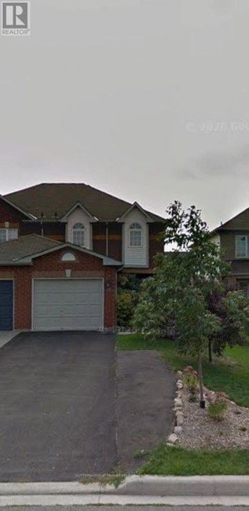Halton Hills (Georgetown) apartment for rent - A house with a driveway and a garage door.