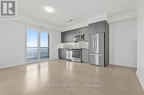 Mississauga (Hurontario) condo for rent - A spacious kitchen with stainless steel appliances and a large window overlooking the city.