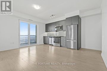 Mississauga (Hurontario) condo for rent - A spacious kitchen with stainless steel appliances and a large window overlooking the city.