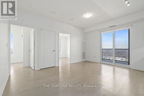 Mississauga (Hurontario) condo for rent - A large, empty room with a view of the city through a large window.